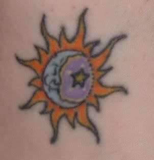 orange ink tattoo on sun_moon_star tribal design